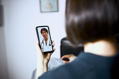 Young adult consulting with doctor via telehealth