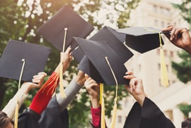 photo of graduates tossing their caps