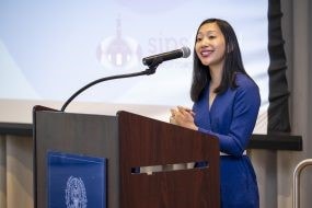 Tiffany Yu speaking at podium