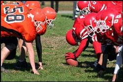 The figure above is a photograph showing two football teams squaring off.