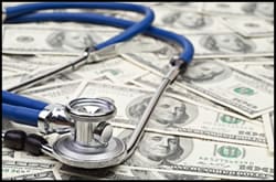 The figure above is a photograph showing a stethoscope on top of $100 bills. 