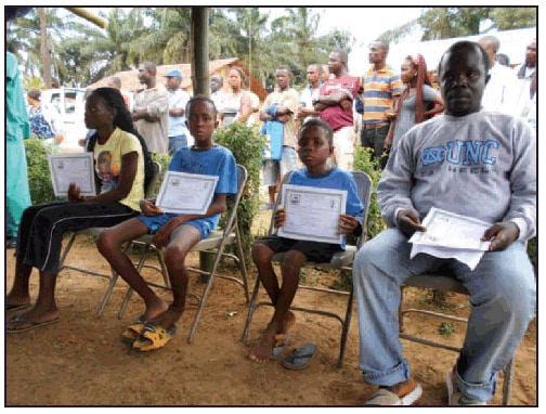 The figure above is a photograph of Ebola survivors, three orphans and their uncle, receiving Certificate of Medical Clearance as part of the Firestone Ebola Survivor Reintegration Program in Firestone District, Liberia, in 2014.