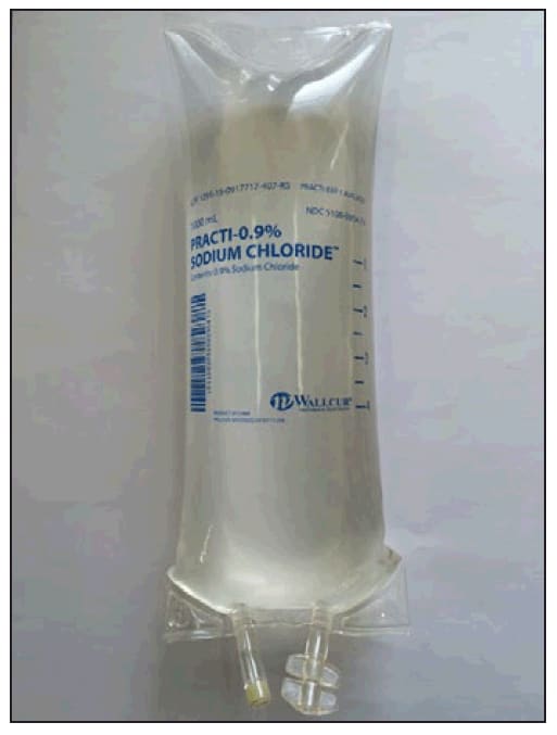 The figure above is a photograph of a sample of the simulated saline product inadvertently administered to multiple patients as sterile intravenous fluid, with reported adverse events in the United States during 2014. The bag is labeled "PRACTI-0.9% Sodium Chloride," and the phrase "Practi-Products for Clinical Simulation" is printed in letters <2 mm in height under the Wallcur logo at the bottom of the bag.