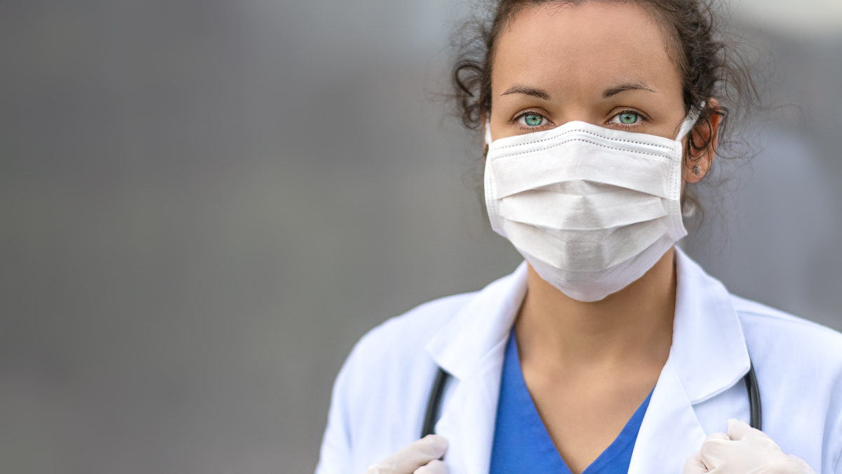 The figure is a photo of a health care provider wearing a face mask.