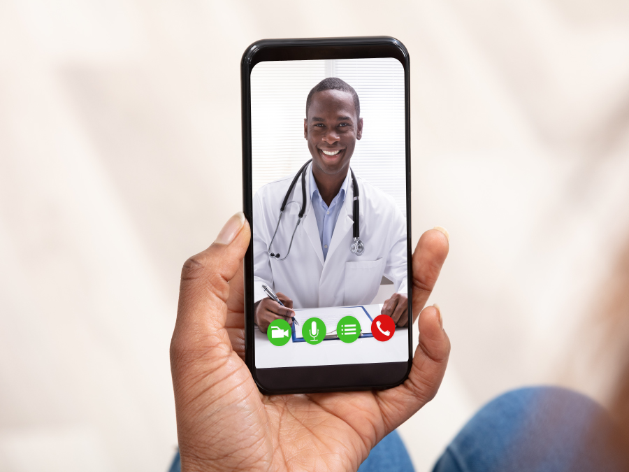 The figure is a photo of a person video chatting with a health care provider on a cell phone.