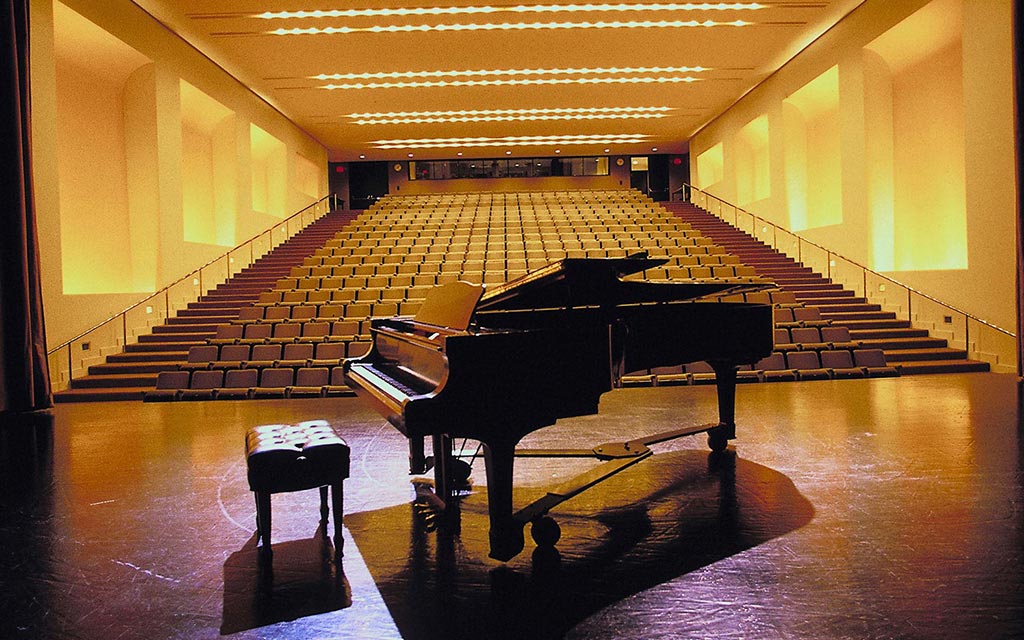 Piano on stage inside the concert hall where the music workshop was held.