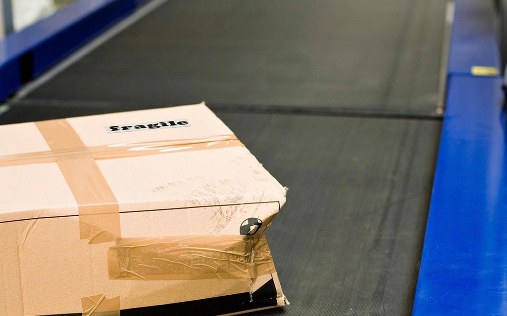 A package moving on postal service conveyer belt.