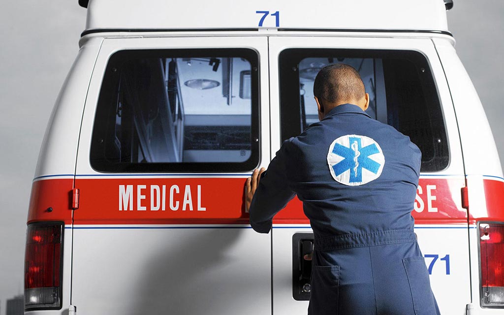 Emergency Medical Services worker opening the door of the EMS vehicle.