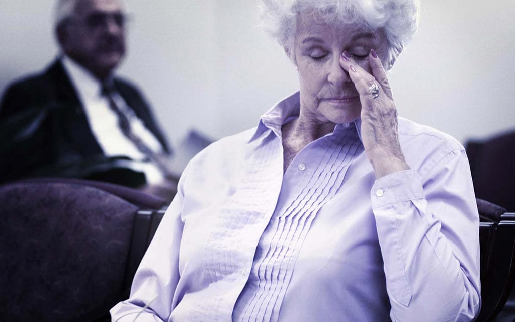 Older woman displaying that she is tired.