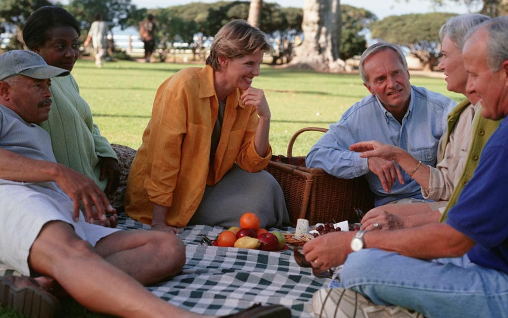 Six older adults at a picnic.