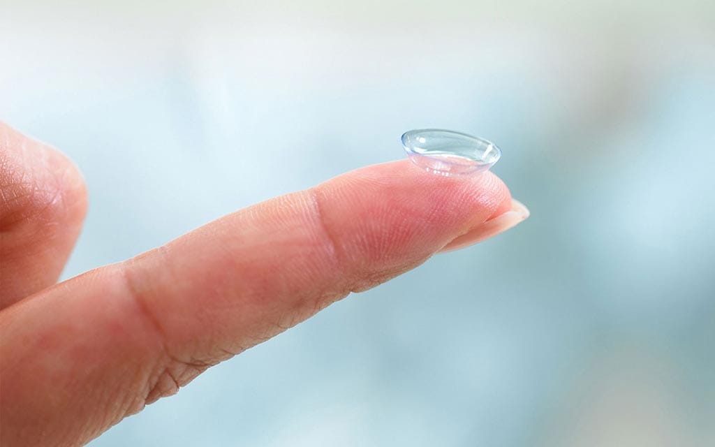 A contact lense on a finger.