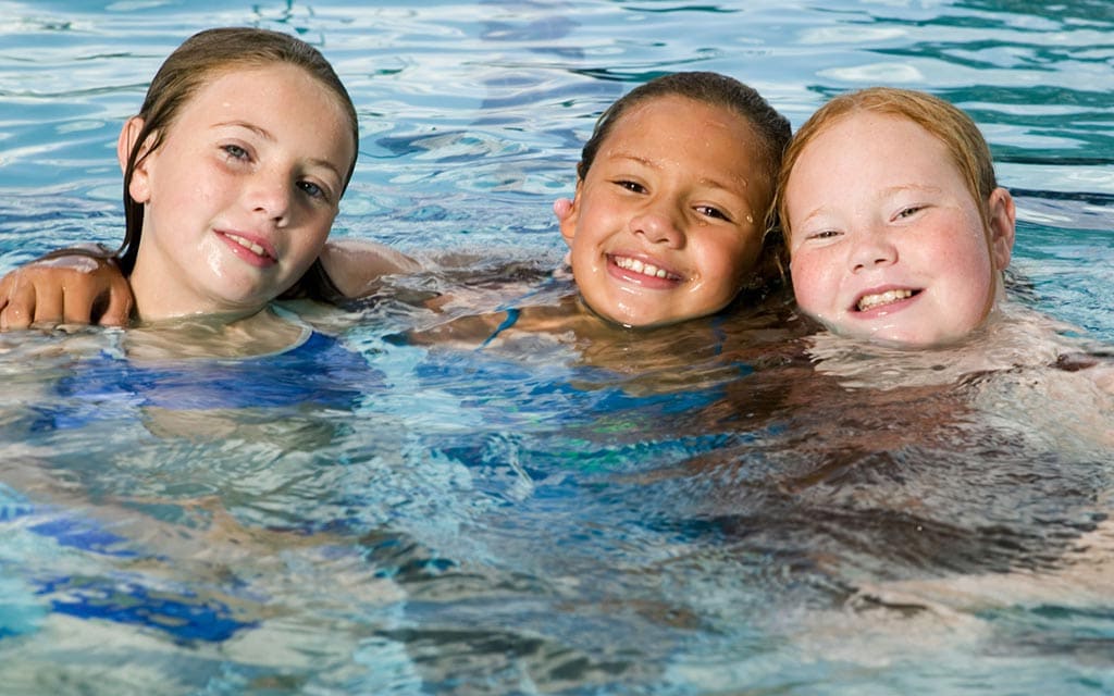 Kids in a swimming pool.