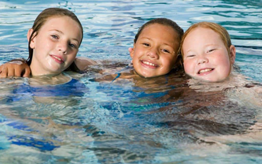 Kids in a swimming pool.