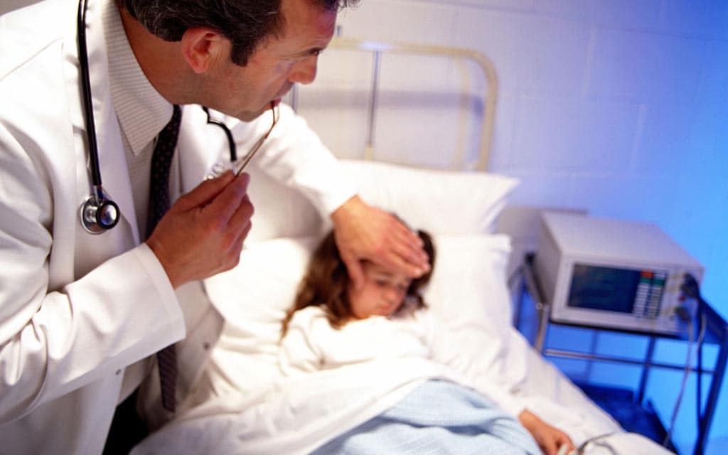 Doctor checking on a hospitalized child.