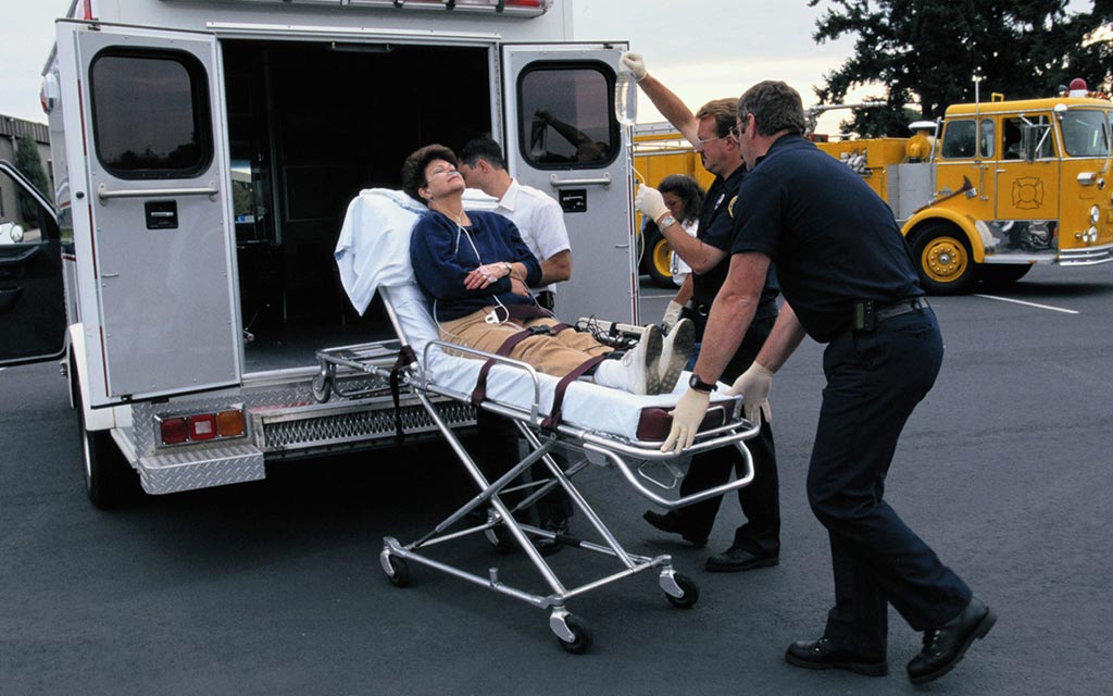 EMS workers loading a person into the EMS vehicle.