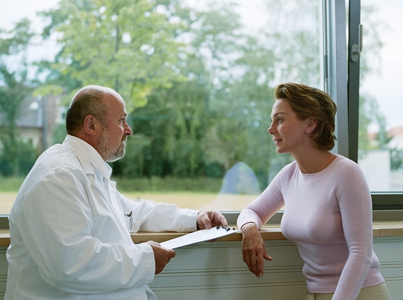 A doctor interviewing a woman.