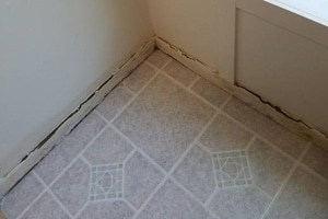 a floor with minor water damage above the baseboards