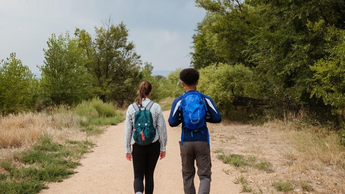 Photo showing two people hiking in protective clothing to prevent mosquito bites.