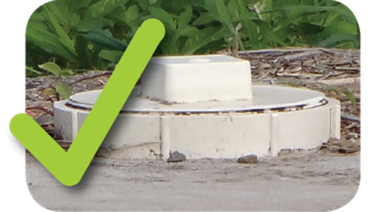 A septic tank with a PVC cap. A check mark is added.