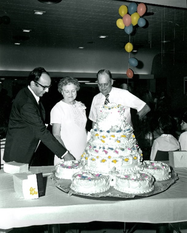 Past CDC personnel cutting a birthday cake