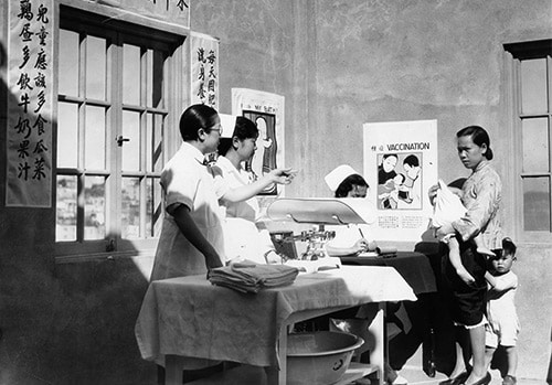 San Francisco History Center, San Francisco Public Library - A doctor coaxing a child with his mother at a Chinatown Well Baby Clinic, San Francisco, 1934 - In 1921, Congress passed the Maternity and Infancy Act to provide instruction in maternity and infant care. Through this funding, “Well Baby Clinics” were held across the country, typically segregated by ethnicity or race. 