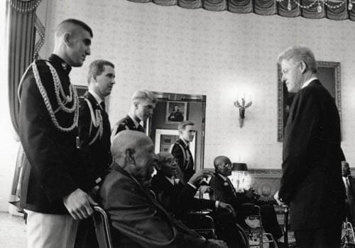 President Clinton with the survivors at the White House