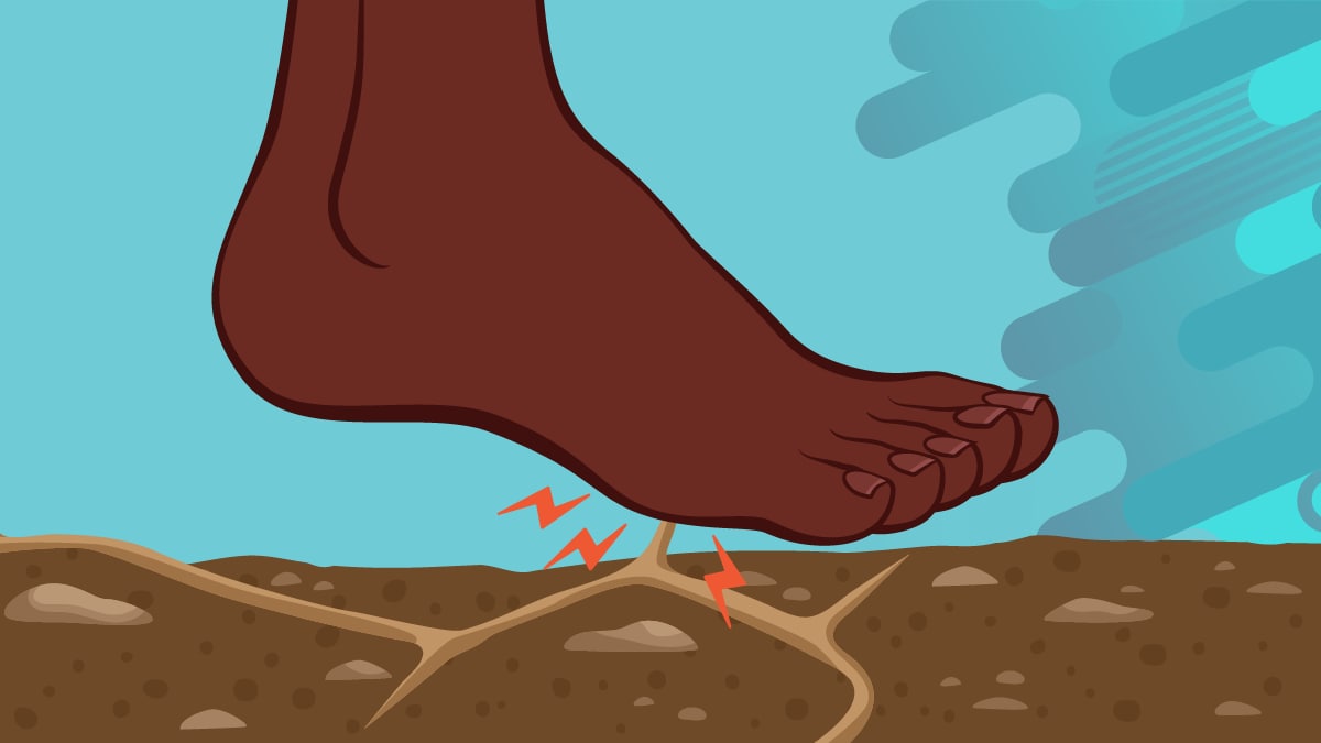 Close up of bare foot stepping on soil