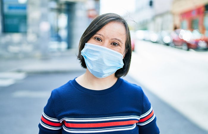 woman with down syndrome wearing a protective mask