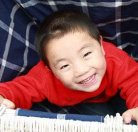 A young asian boy with a big smile 