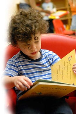 A young boy reading a book 