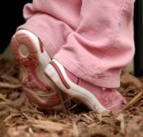 A little girl's pink shoes