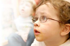 Boy with glasses listening in class