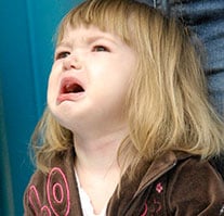 A toddler girl crying