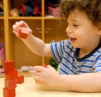 A toddler playing with blocks