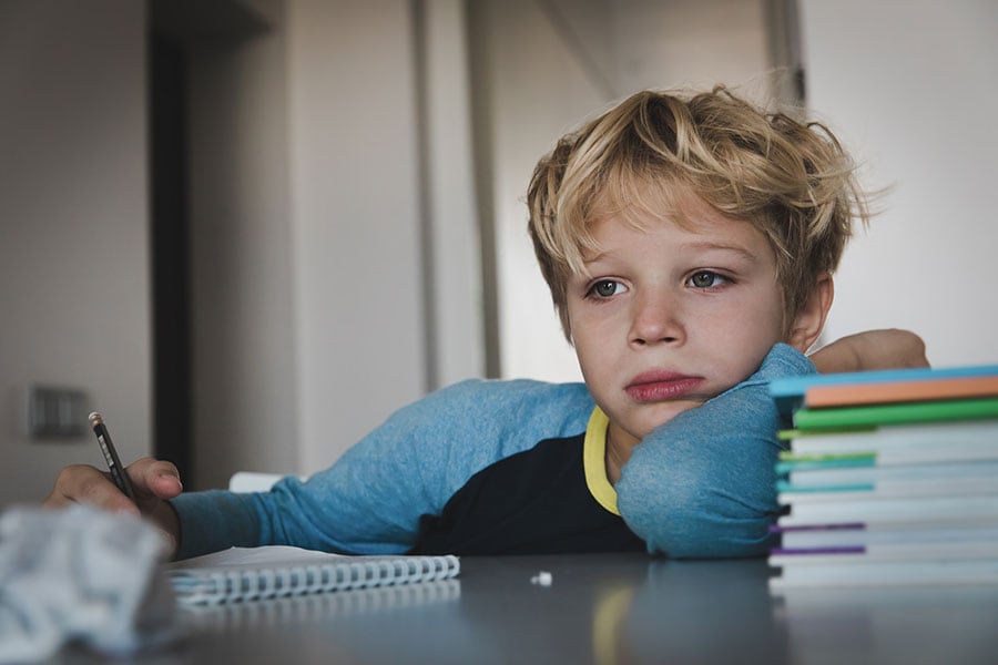 A child frustrated with his schoolwork, Some children have inattention and many worries