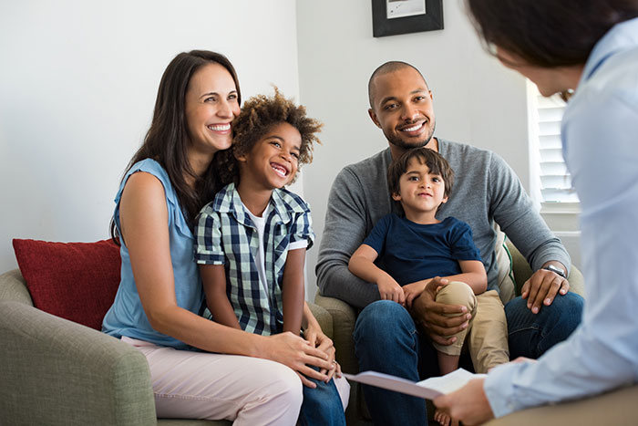 Therapist talking with parents and child