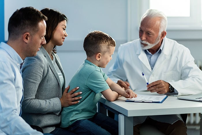 Boy with his parents at doctor's appointment