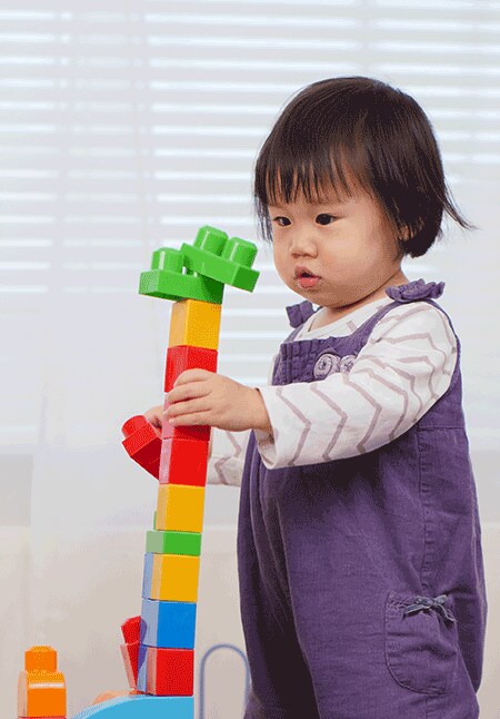 Asian girl stacking blocks