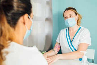 A doctor talking to a woman