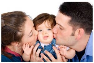 Photo: Family kissing child