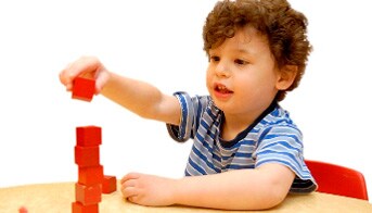 Boy stacking blocks