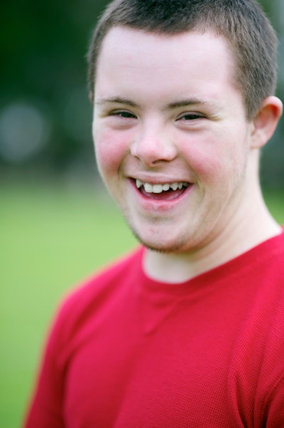 Boy with Down syndrome wearing a red shirt