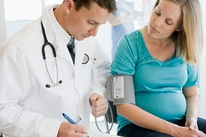 Pregnant woman talking with her doctor