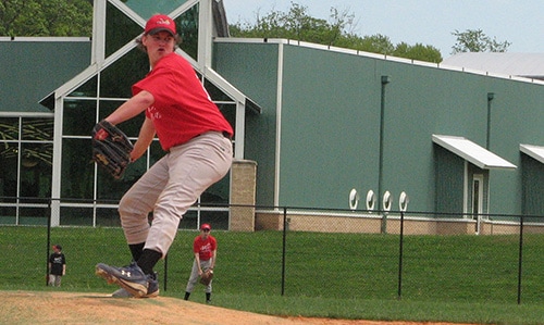 Taylor on a baseball field pitching.