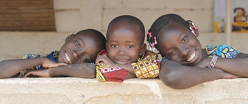 Three Adorable African Children Posing Outdoors