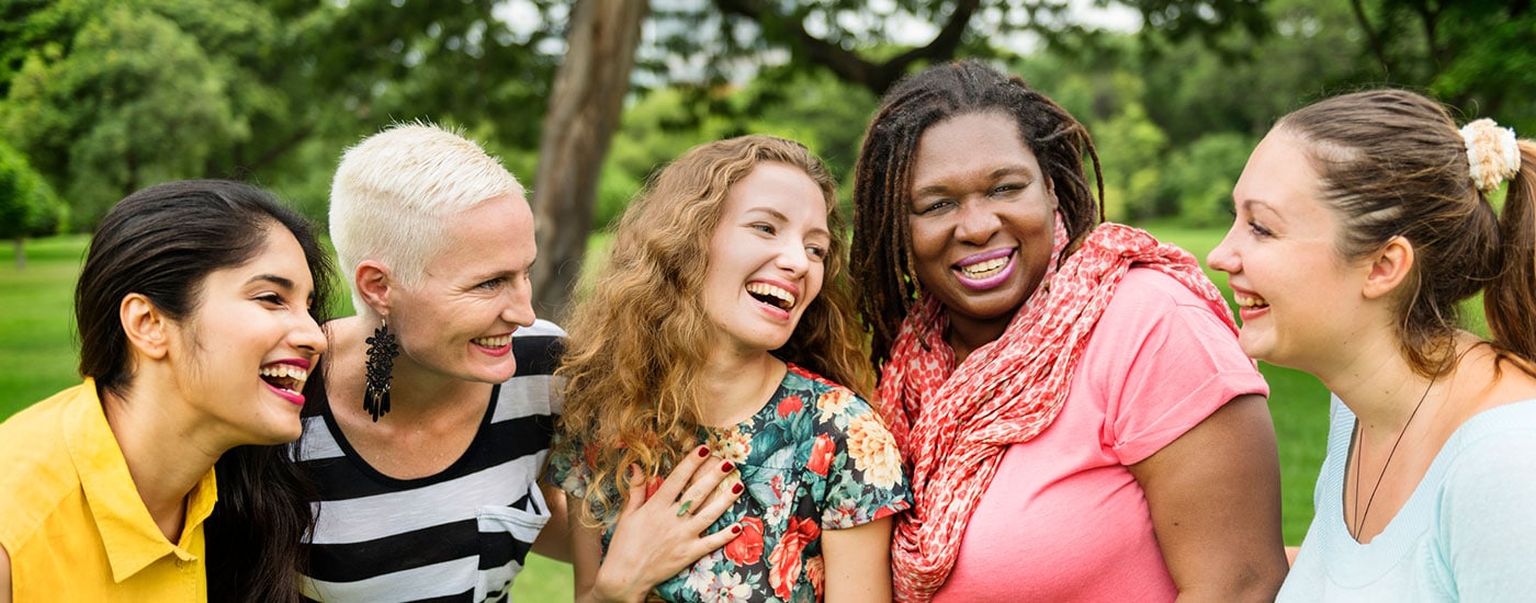 Diverse women smiling and socializing in nature
