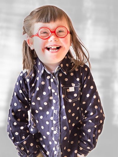 Little girl with glasses laughing