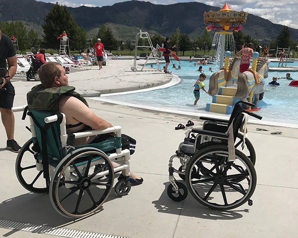 Man in a wheelchair by the pool