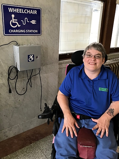 Woman charging her wheelchair