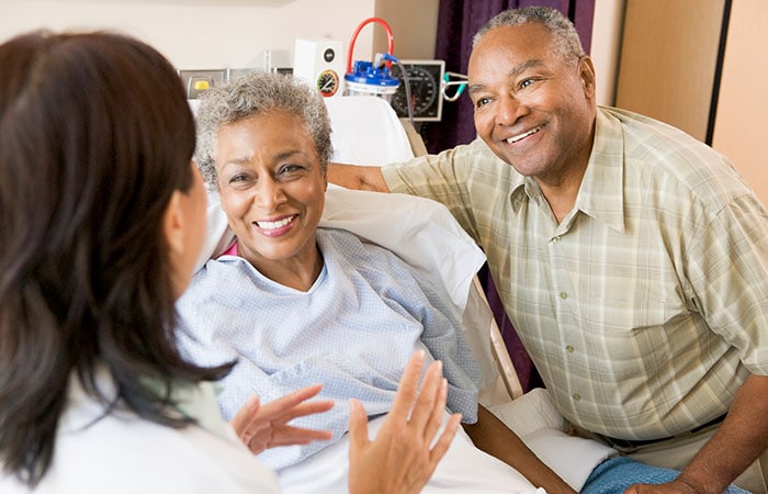 A doctor talking with a senior couple